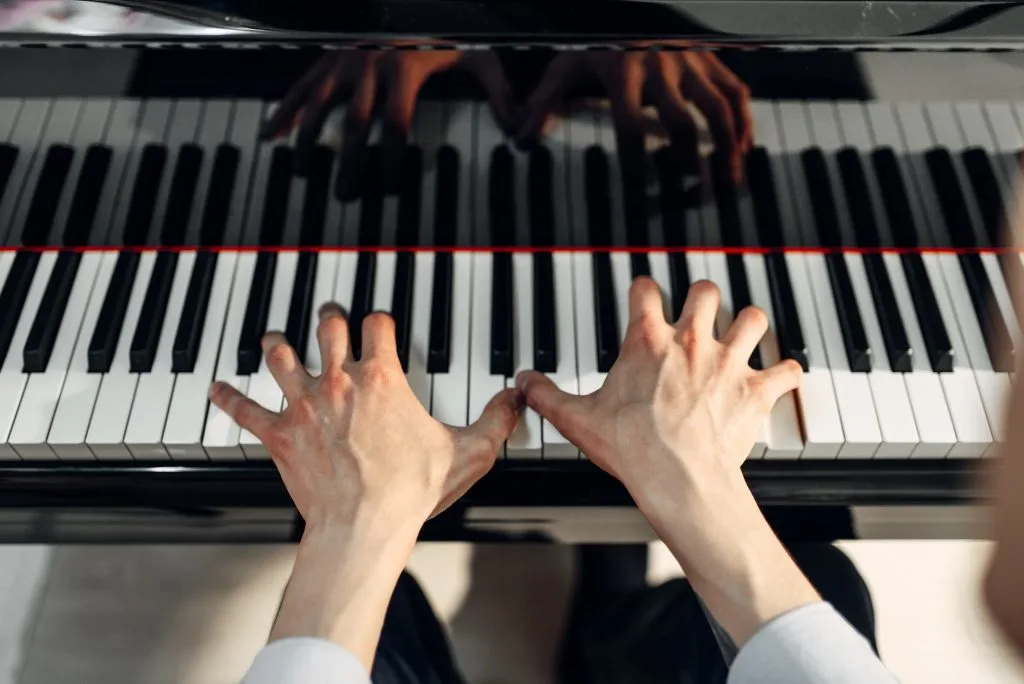 Mies soittaa pianolla